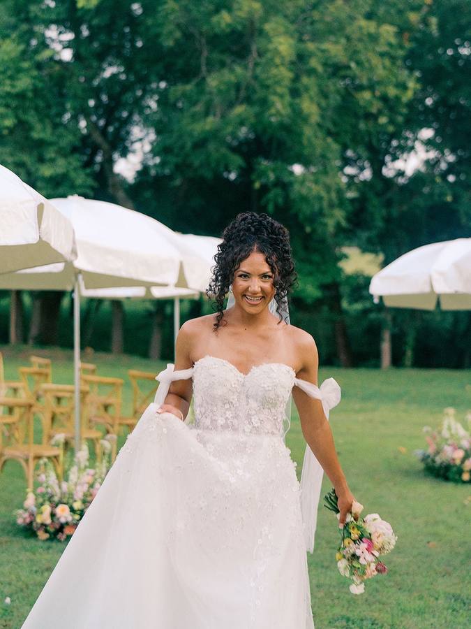 Bride on the lawn under white umbrellas at River Road Venue