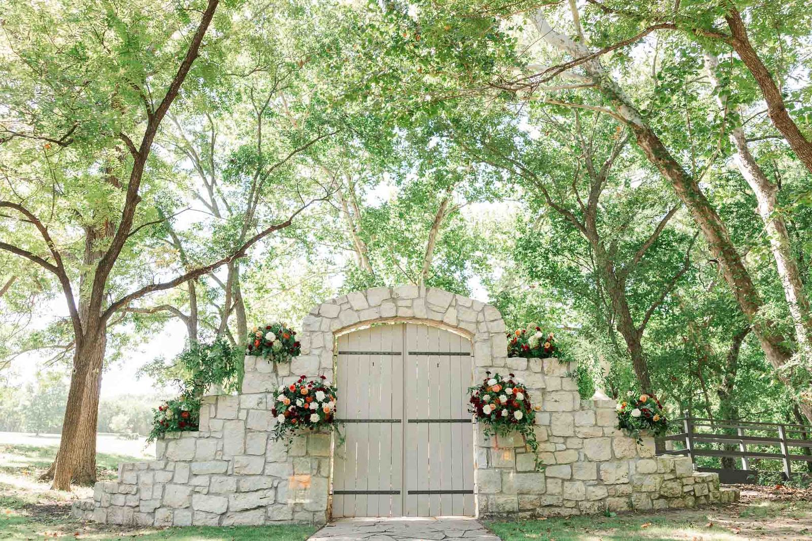 Stone gates leading into the meadow at River Road Venue